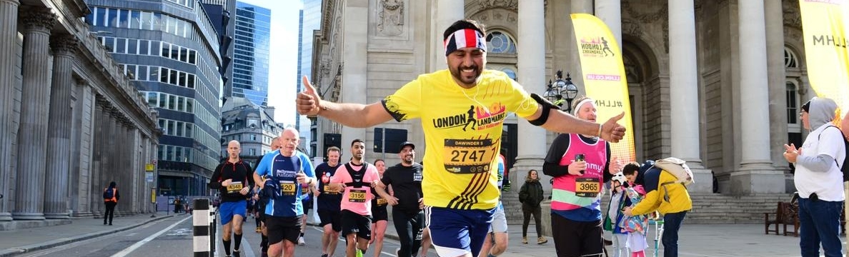 A man in a London Landmarks half marathon shirt, running the course